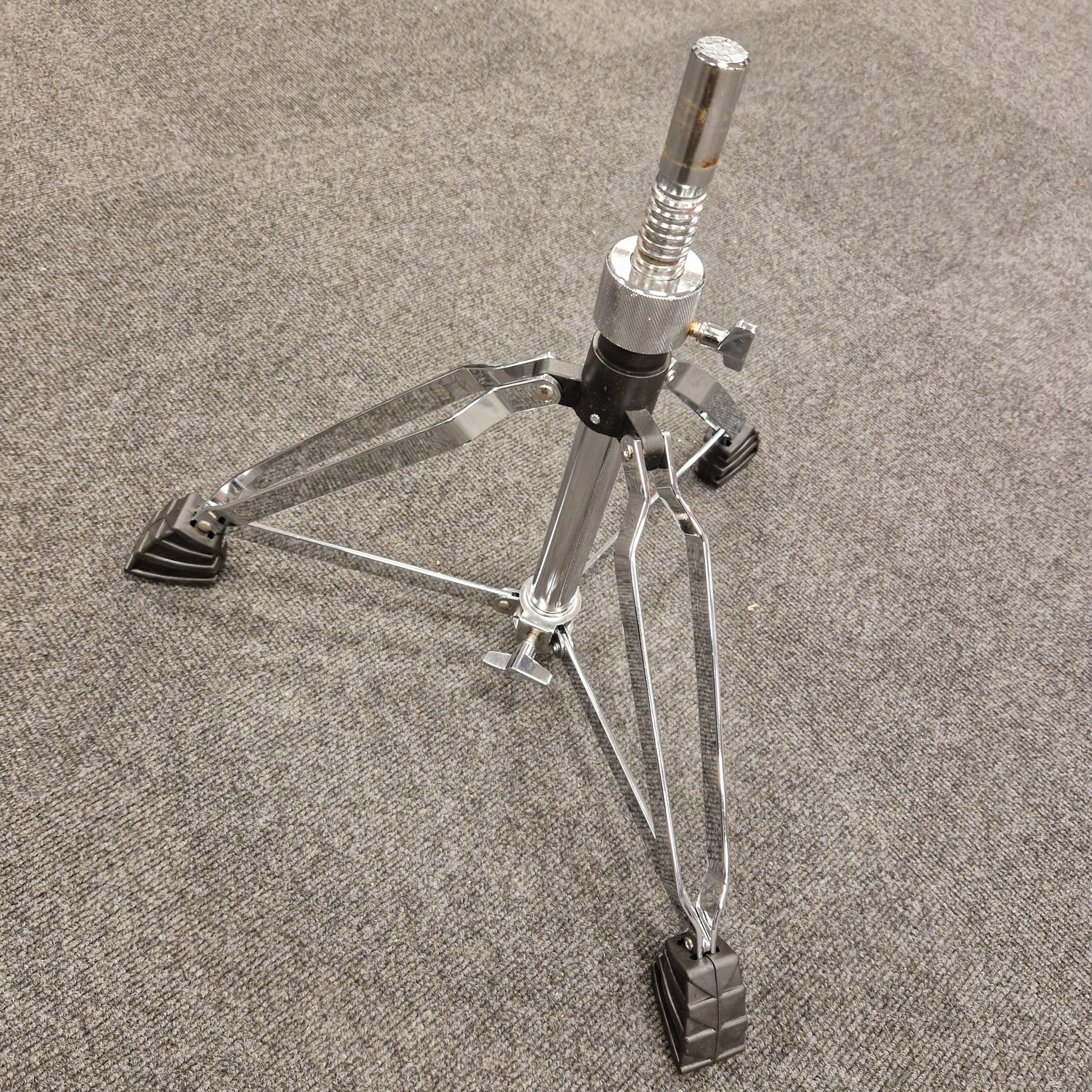 Pre-Owned Donner Drum stand on a gray textured surface
