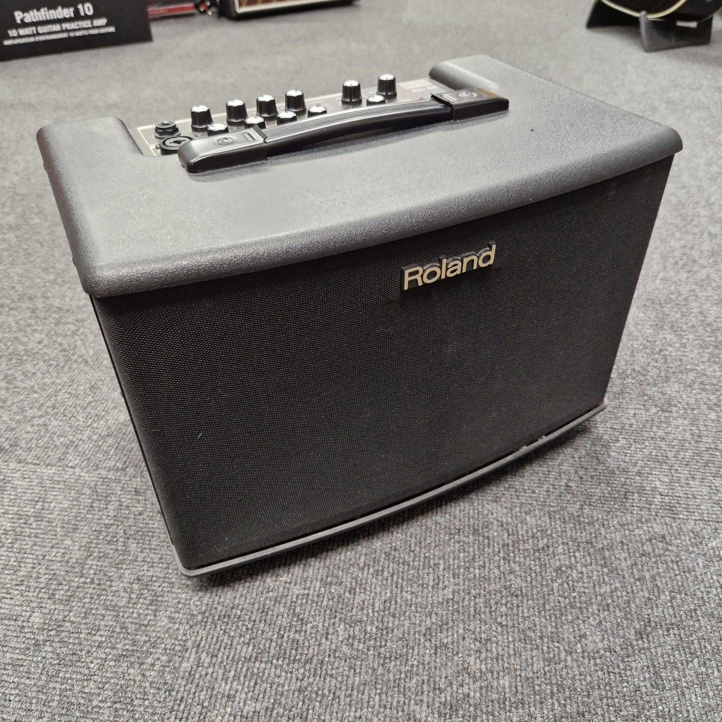 Pre-Owned Roland Roland keyboard amplifier on a textured surface