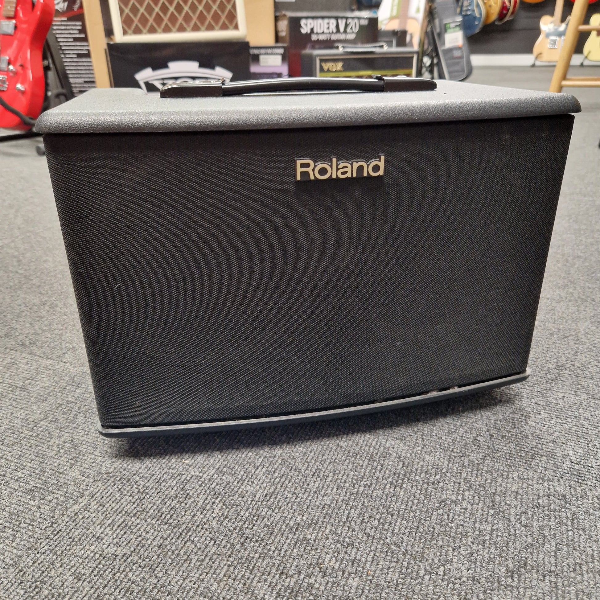 Pre-Owned Roland Black Roland case on a gray surface with a blurred background