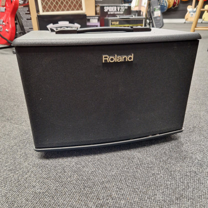 Pre-Owned Roland Black Roland case on a gray surface with a blurred background