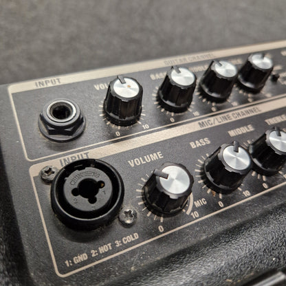 Pre-Owned Roland Close-up of audio equipment with knobs and connectors on a gray background