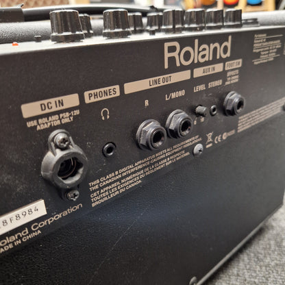 Pre-Owned Roland Close-up of a Roland electronic device with control knobs and labels.