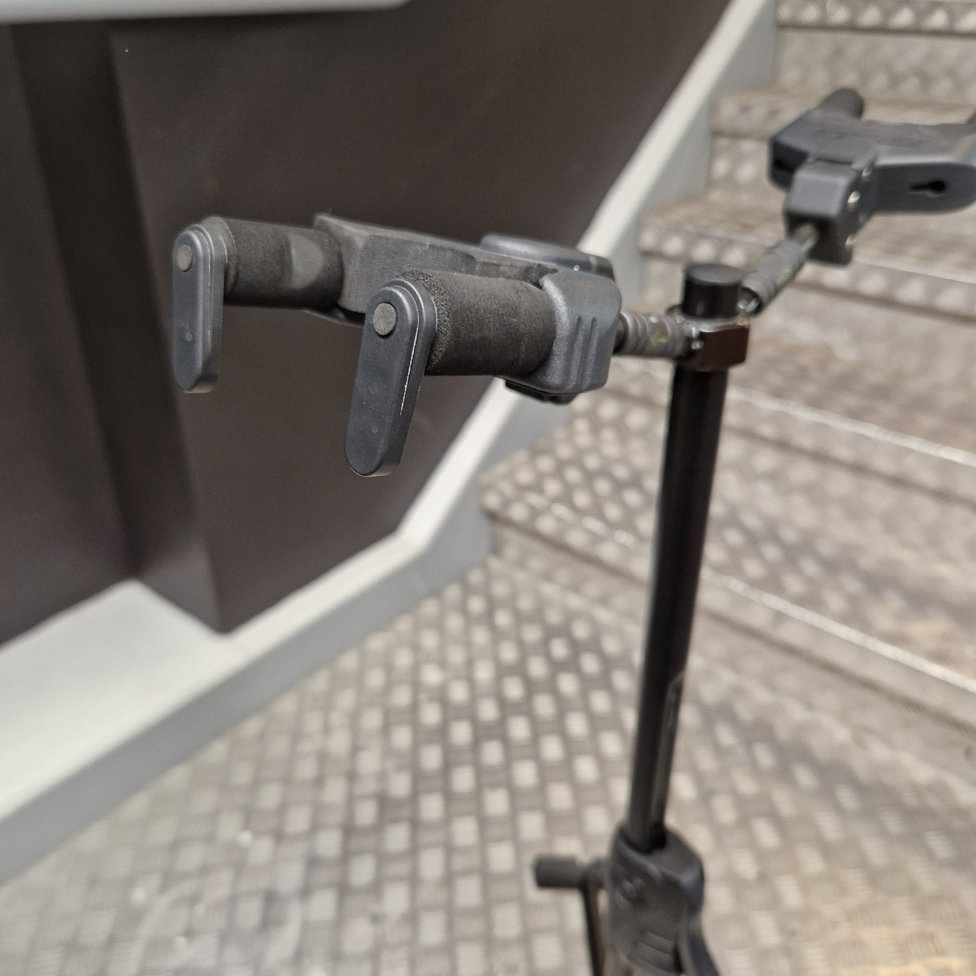 Pre-Owned Hercules Close-up of a metal clamp on a gray surface with a tiled wall background