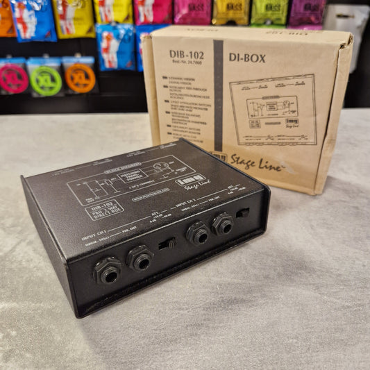 Pre-Owned Stageline Black audio device with wiring on a gray surface, with a cardboard box labeled 'DI-BOX' in the background.