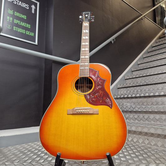 Pre-Owned Epiphone Acoustic guitar on a metallic surface with a staircase in the background