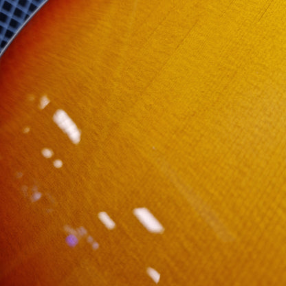 Pre-Owned Epiphone Close-up of a textured orange surface with white spots
