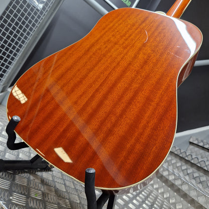Pre-Owned Epiphone Close-up of a wooden guitar on a stand with a metallic floor background