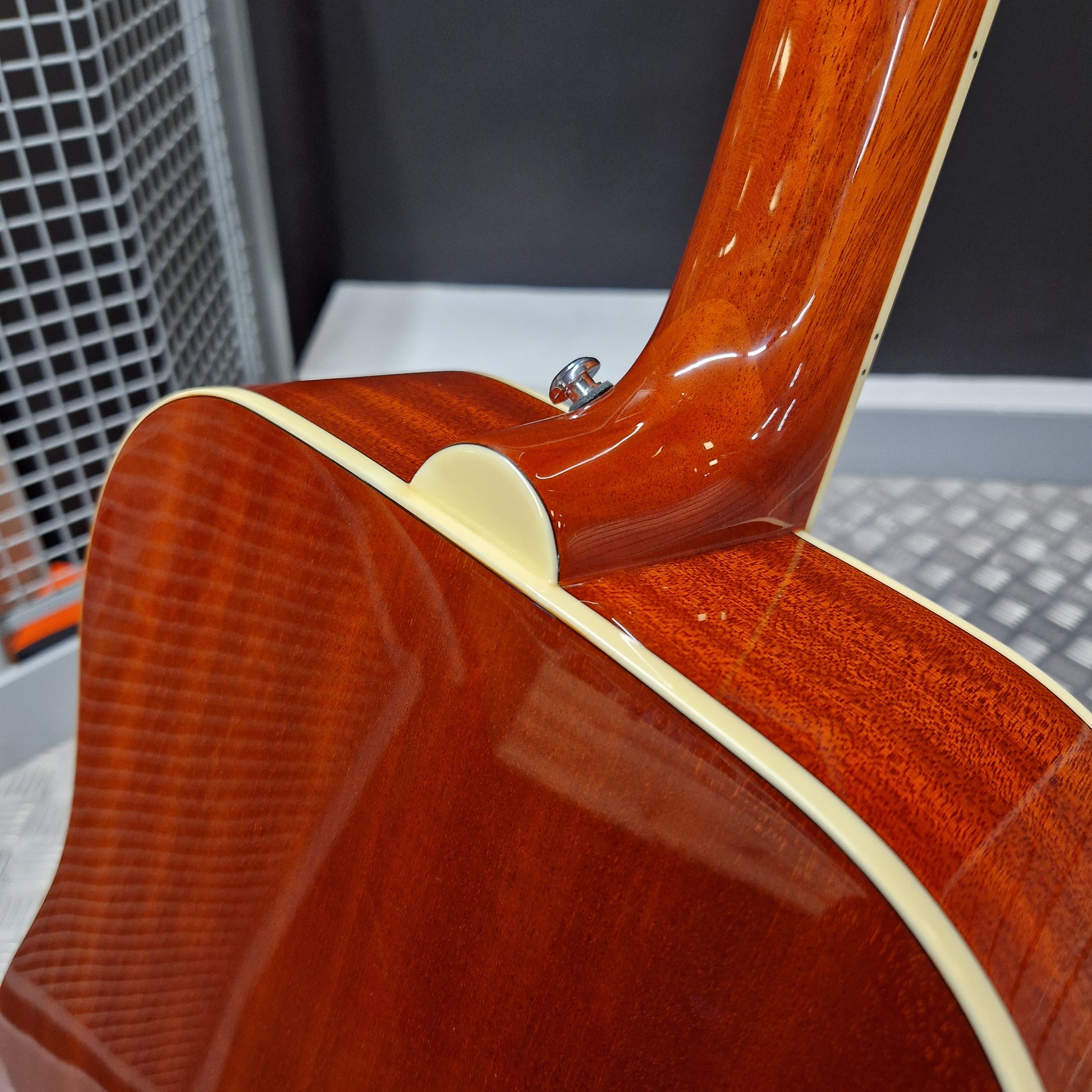 Pre-Owned Epiphone Close-up of a wooden acoustic guitar body with a blurred background