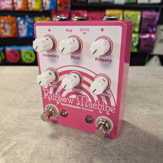 Pre-Owned Earthquaker Pink and white guitar effects pedal with 'Rainbow Machine' branding on a textured surface.
