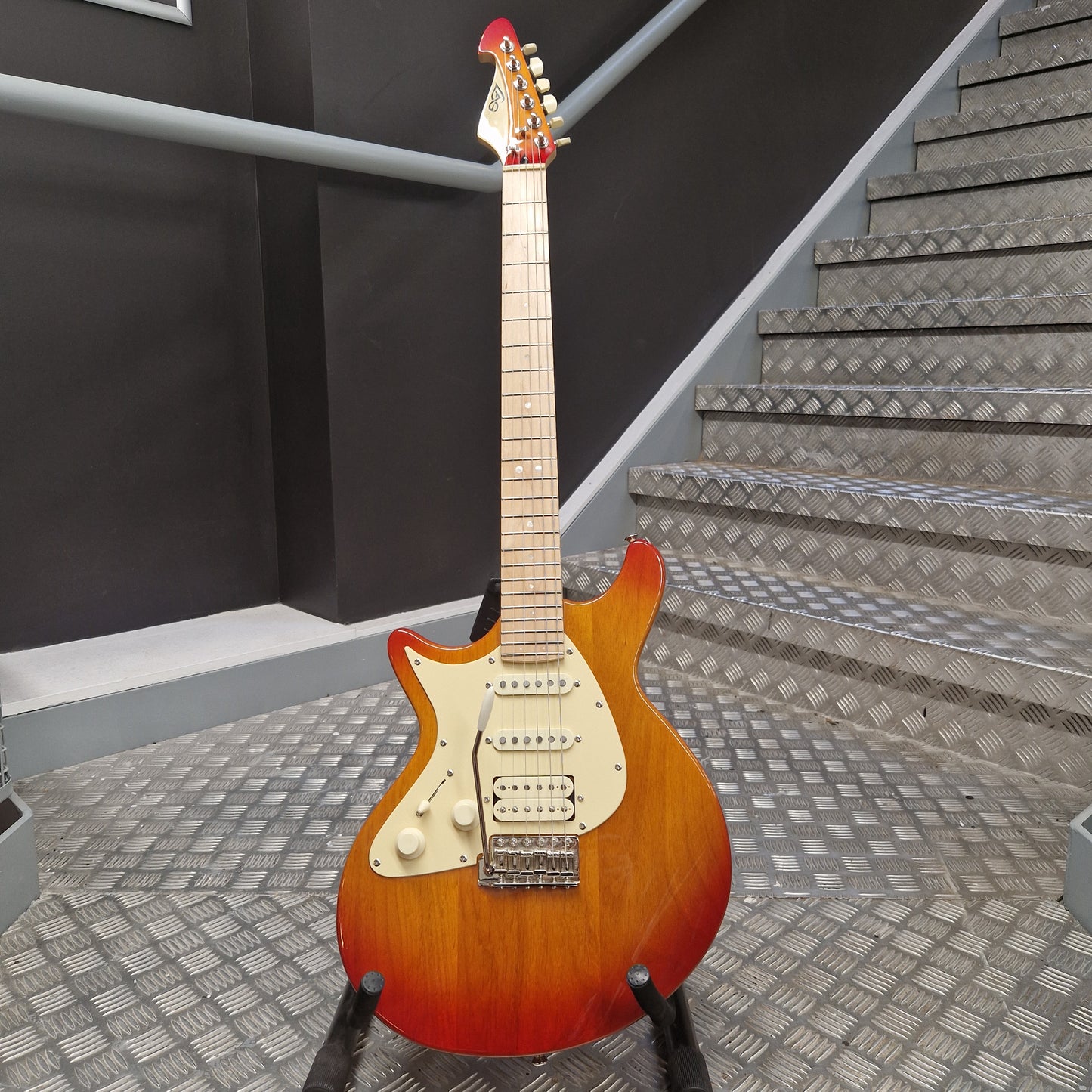 Pre-Owned Lag Electric guitar on a staircase with acoustic panels in the background