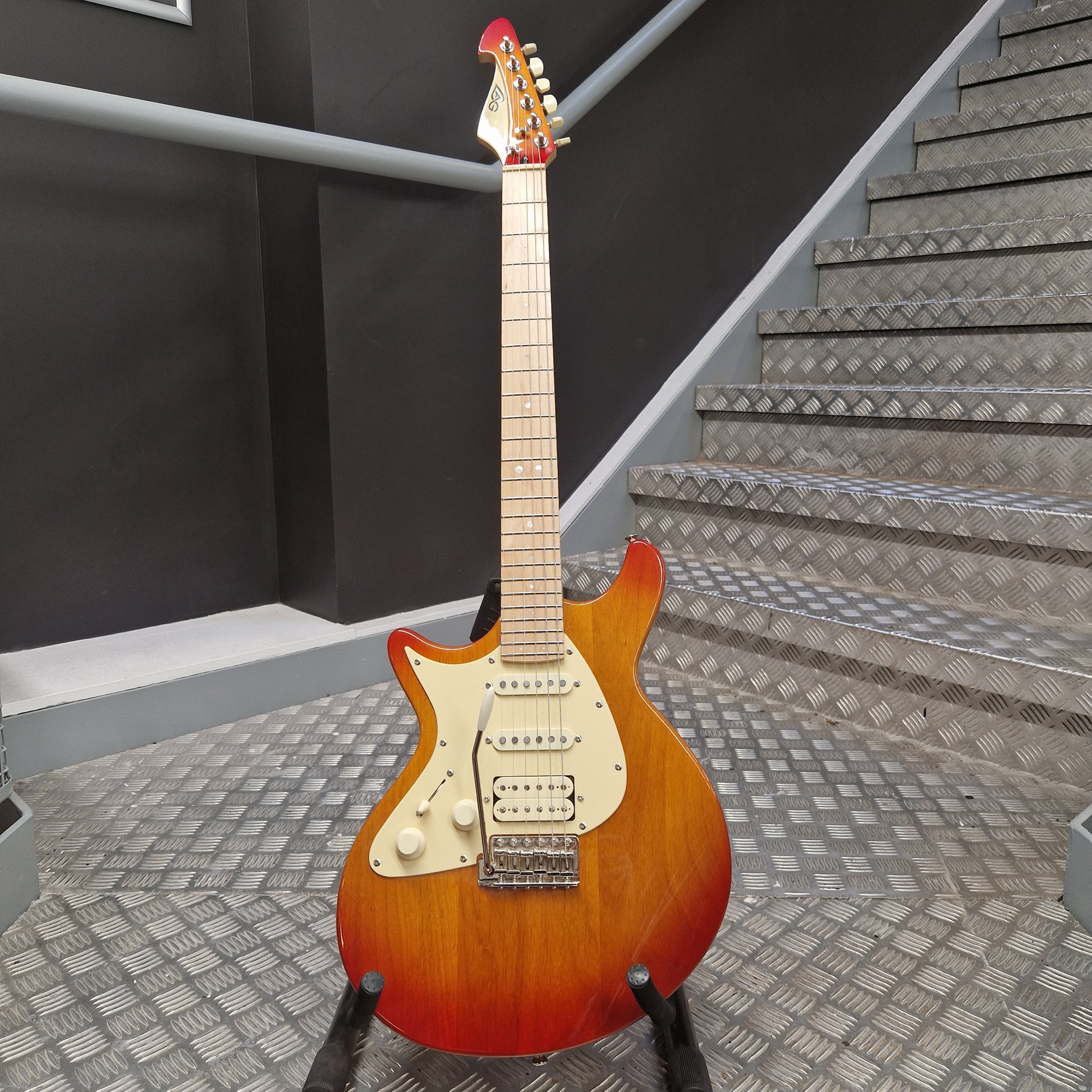 Pre-Owned Lag Electric guitar on a staircase with acoustic panels in the background
