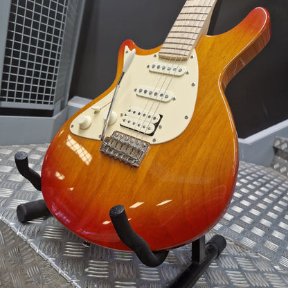 Pre-Owned Lag Electric guitar with a sunburst finish on a stand against a metallic background