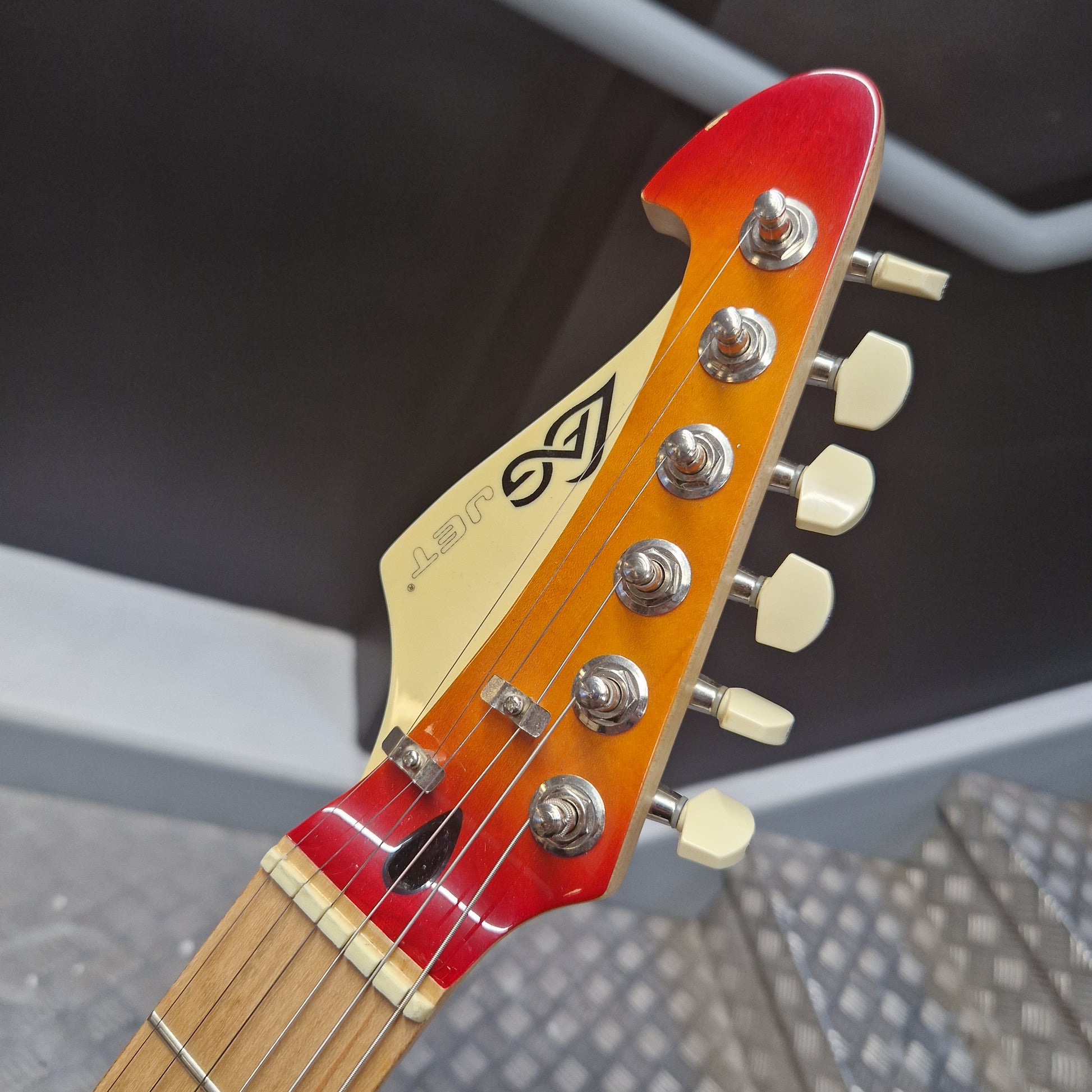 Pre-Owned Lag Close-up of a guitar headstock with brand logo against a blurred background