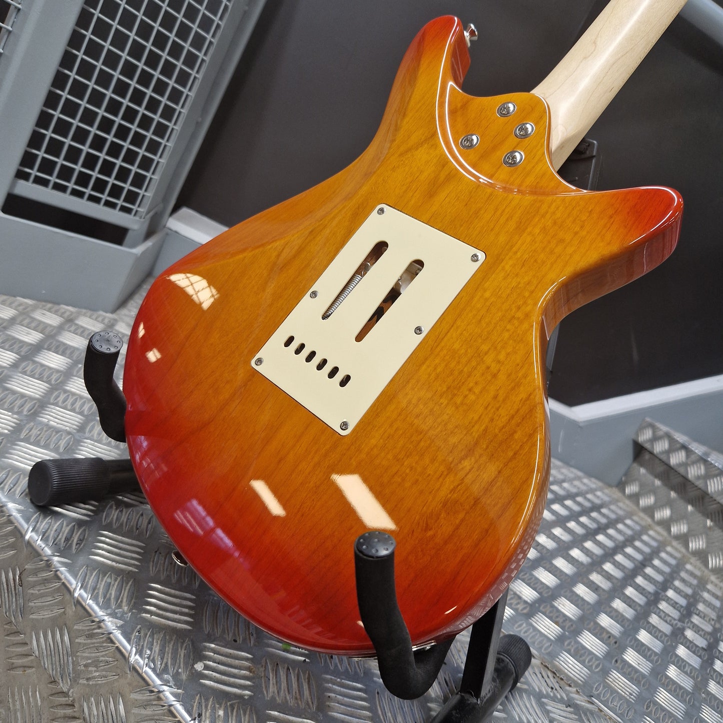 Pre-Owned Lag Electric guitar with a sunburst finish on a metal surface
