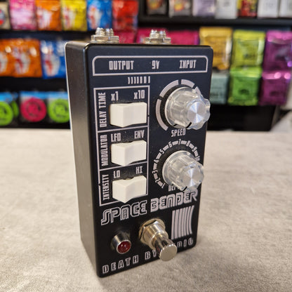 Pre-Owned Death by Audio Guitar effects pedal with 'Space Bender' branding on a gray surface.