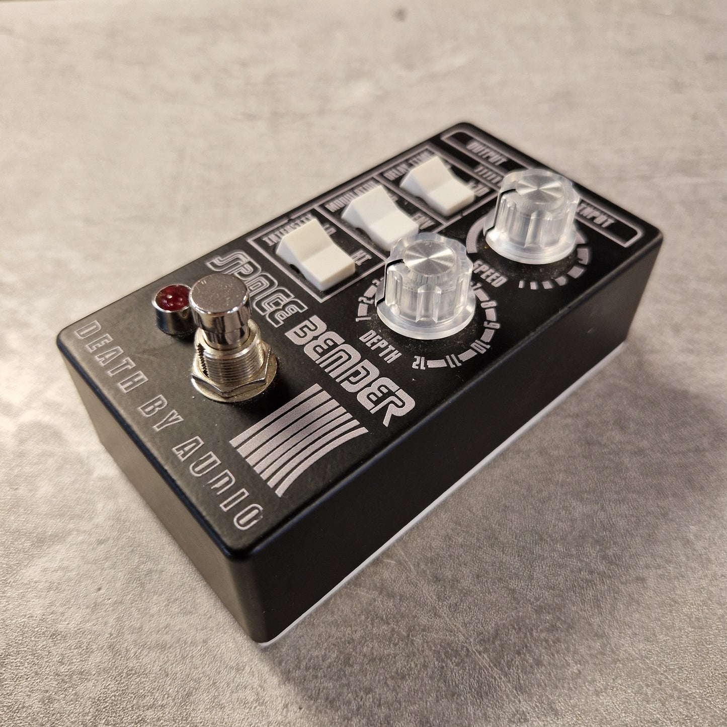 Pre-Owned Death by Audio Guitar effects pedal with 'Death by Audio' branding on a textured surface