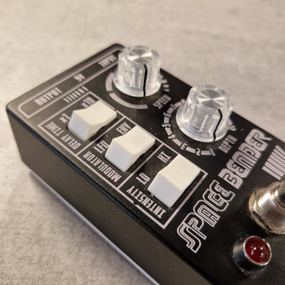 Pre-Owned Death by Audio Close-up of a guitar effects pedal with 'Space Bandit' branding on a textured surface.