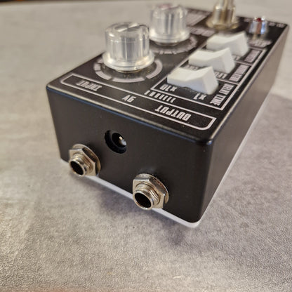 Pre-Owned Death by Audio Guitar effects pedal with knobs and jacks on a gray surface