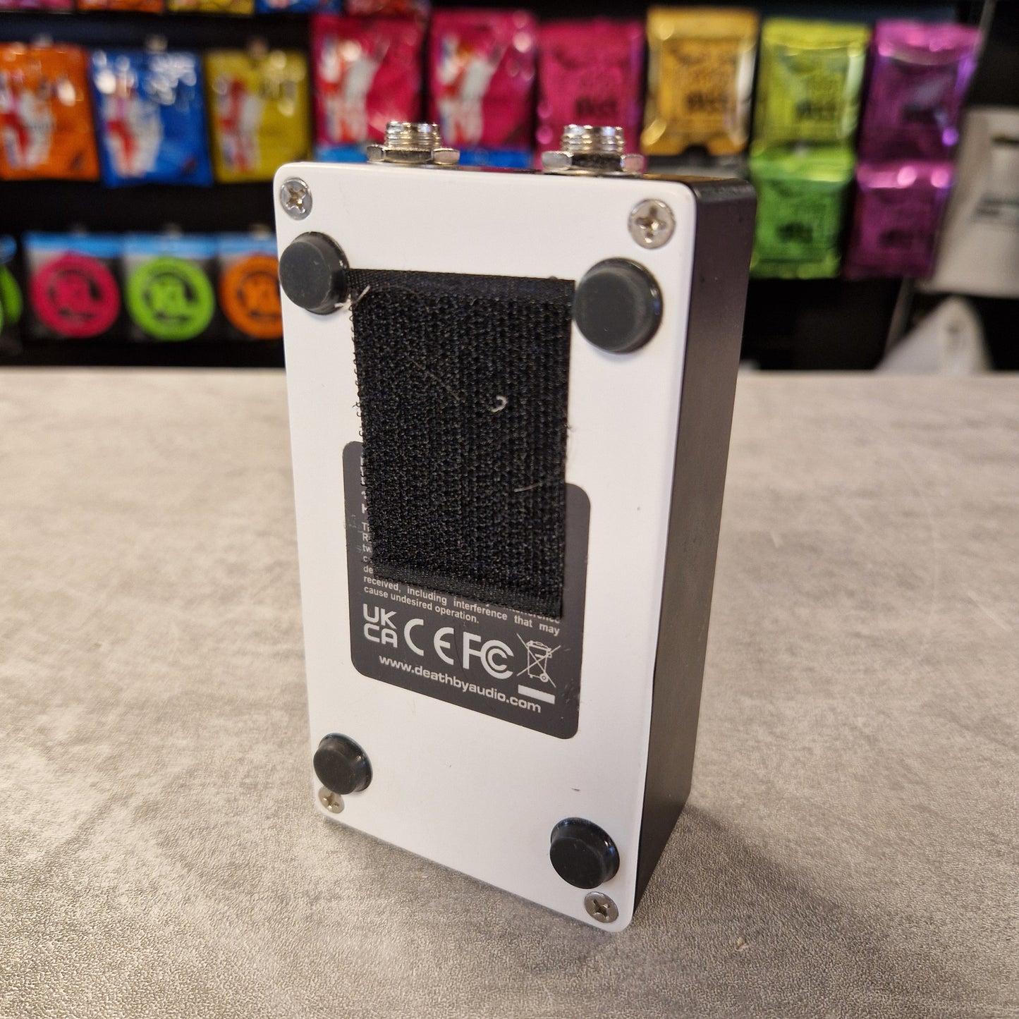 Pre-Owned Death by Audio Guitar effects pedal with visible branding on a textured surface