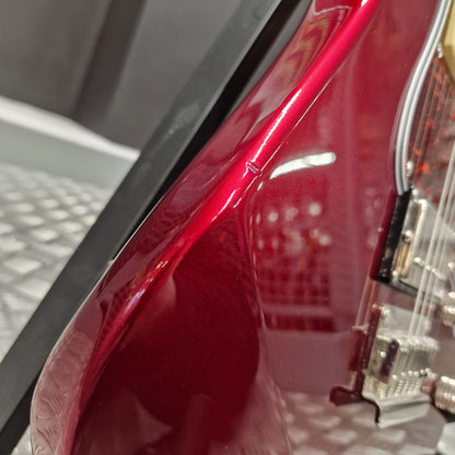 Pre-Owned Yamaha Close-up of a red car's side mirror with a blurred background