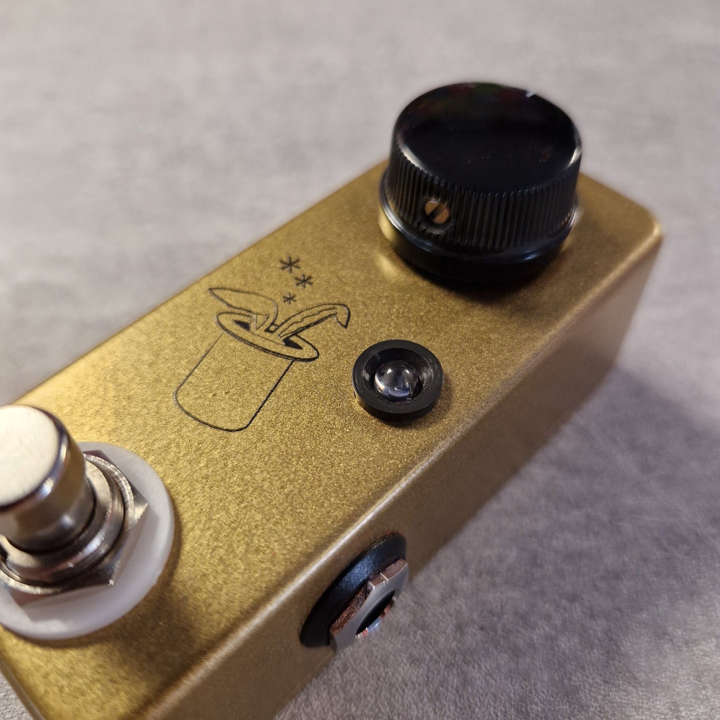 Pre-Owned JHS Gold guitar effects pedal with a black knob and switch on a gray background