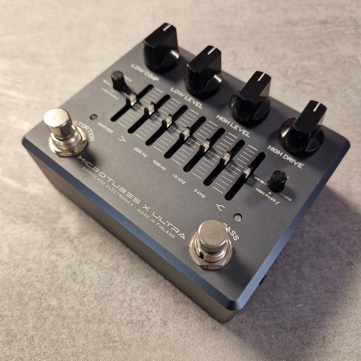 Pre-Owned Darkglass Guitar effects pedal with control knobs and labels on a textured surface