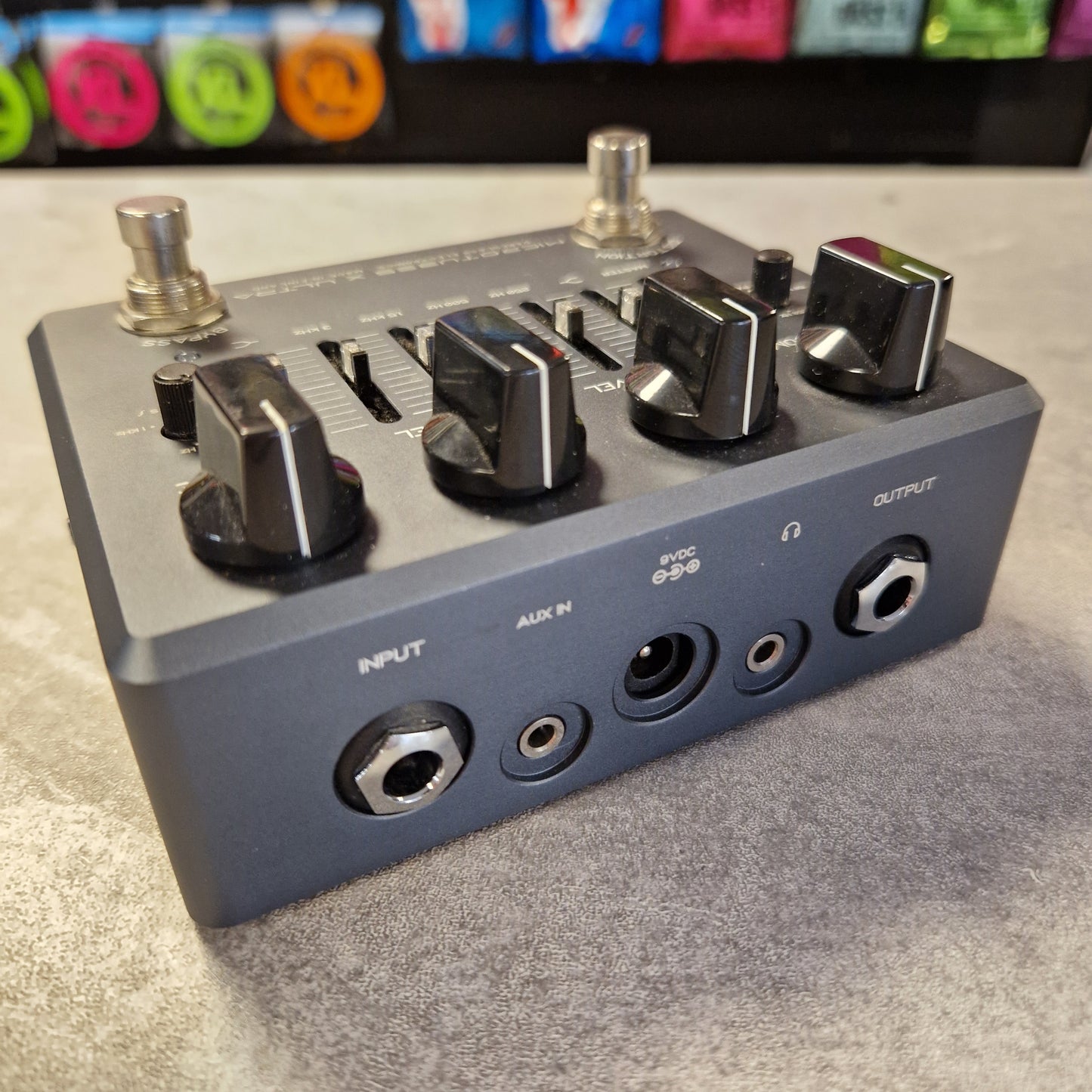 Pre-Owned Darkglass Audio effects pedal with various knobs and connectors on a gray surface.