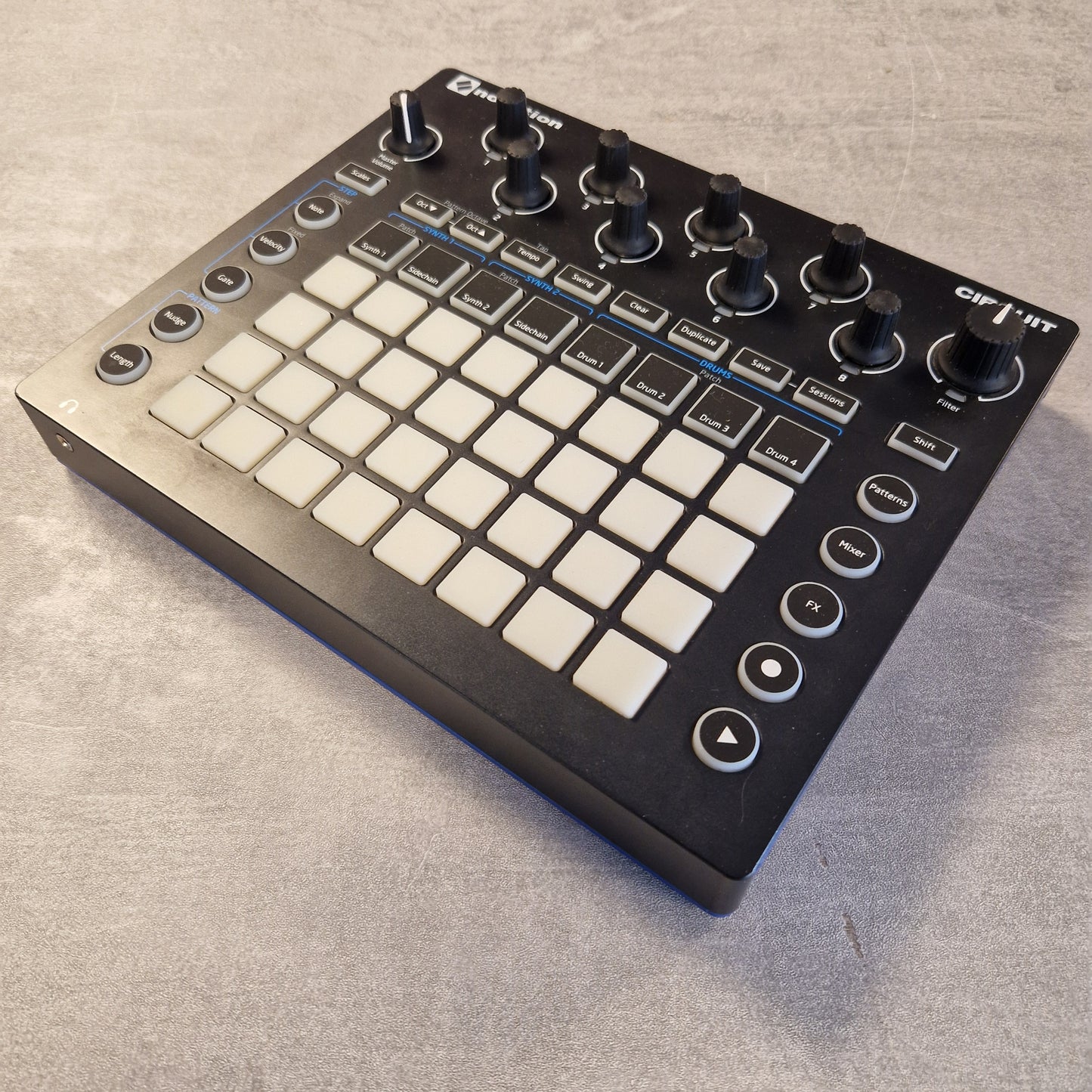 Pre-Owned Novation Music controller with buttons and knobs on a gray surface