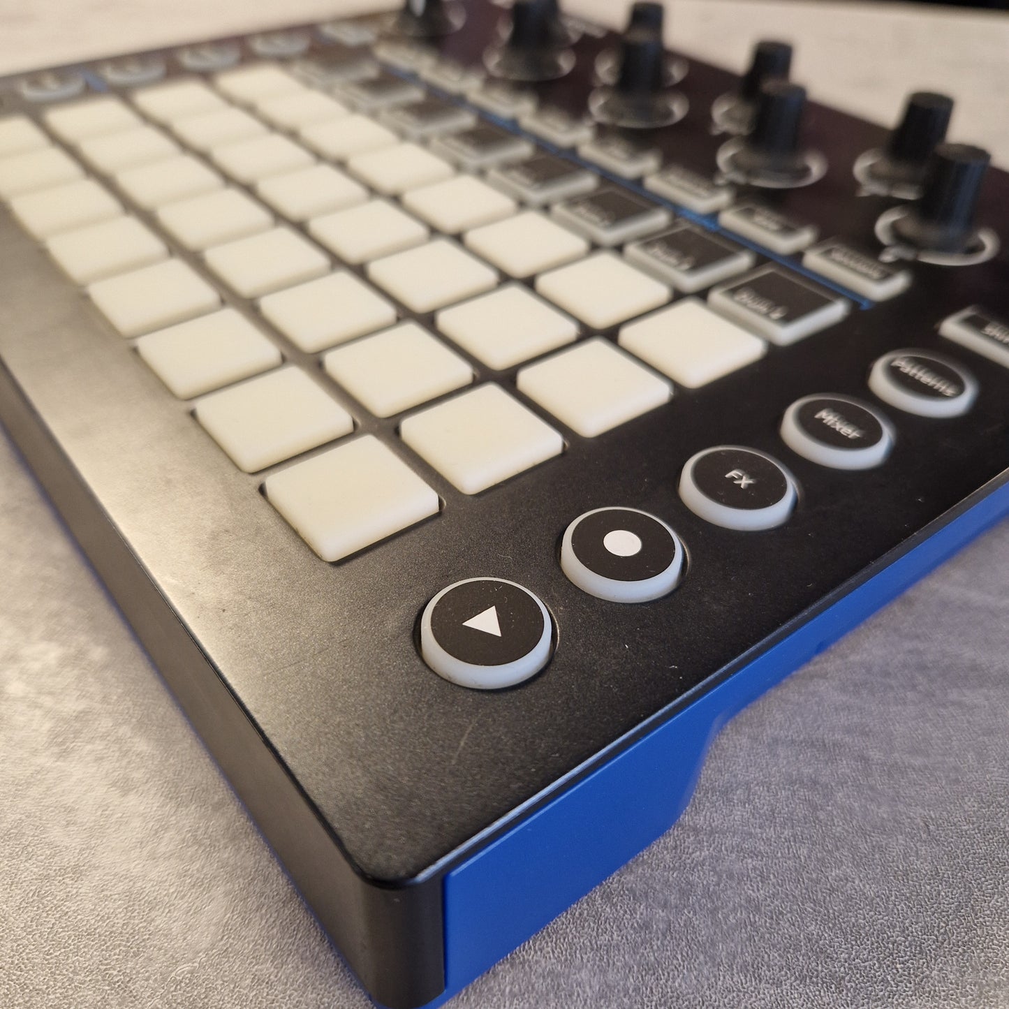 Pre-Owned Novation Close-up of a control panel with buttons and a joystick on a textured surface