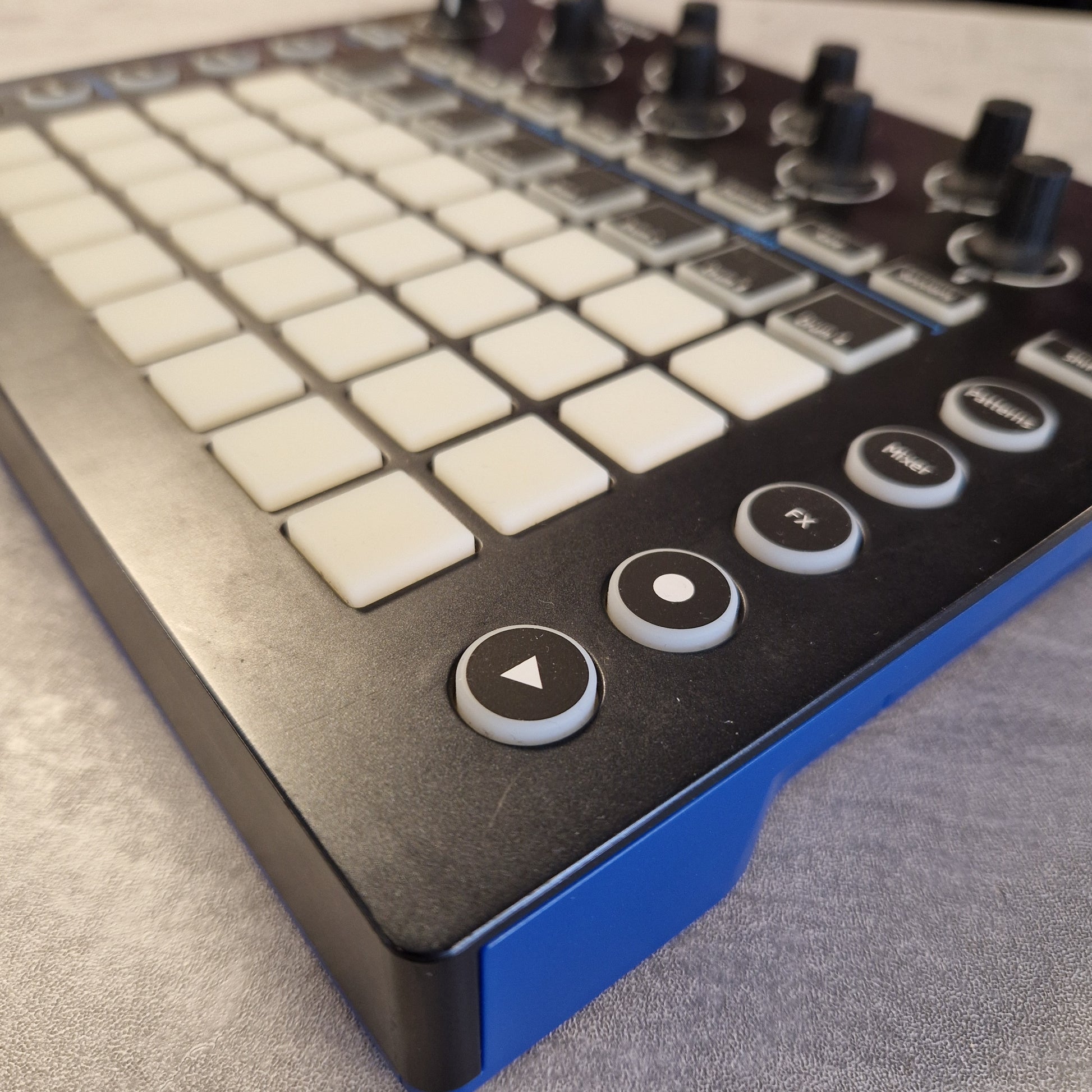 Pre-Owned Novation Close-up of a control panel with buttons and a joystick on a textured surface