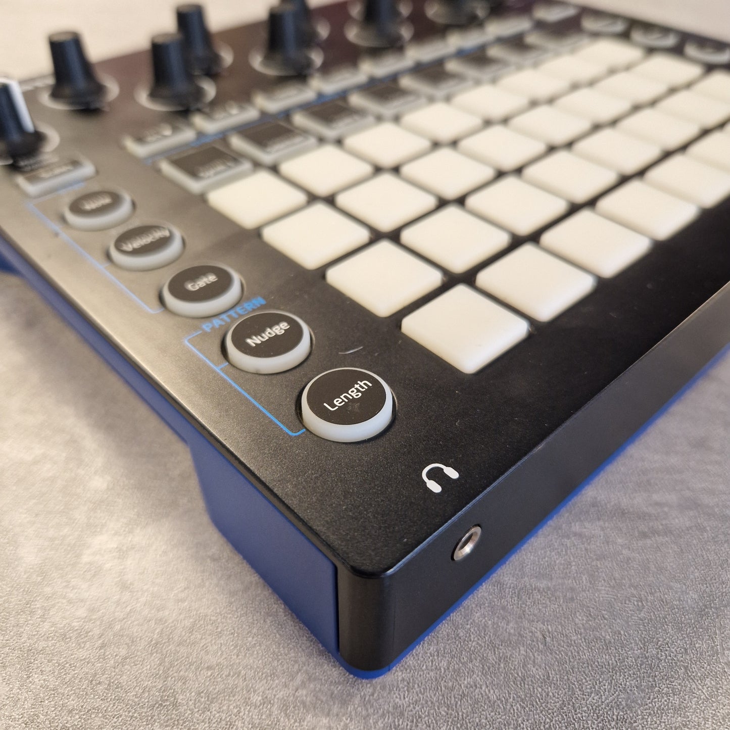 Pre-Owned Novation Close-up of a control panel with buttons and knobs on a textured surface