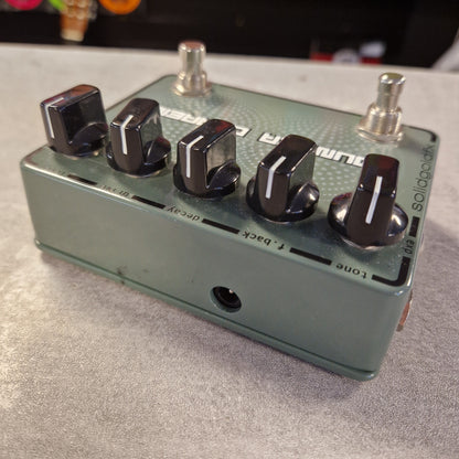 Pre-Owned SolidGoldFx Guitar effects pedal with multiple knobs on a gray surface