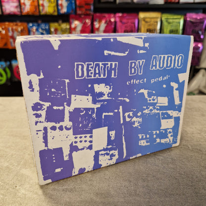 Pre-Owned Death By Audio Blue notebook with white text and patterns on a gray surface