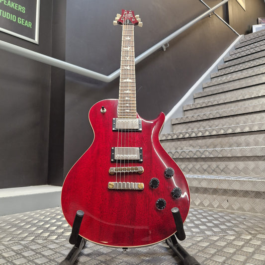 Pre-Owned PRS SE McCarty 594 Red electric guitar on a stand against a neutral background