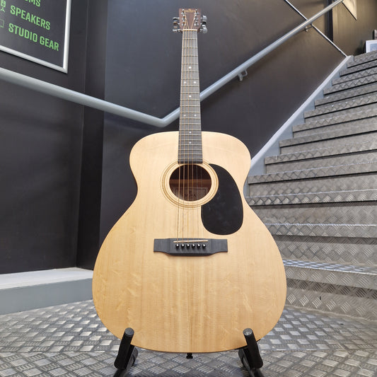 Pre-Owned Sigma 000ME Acoustic guitar on a stand in a room with acoustic panels