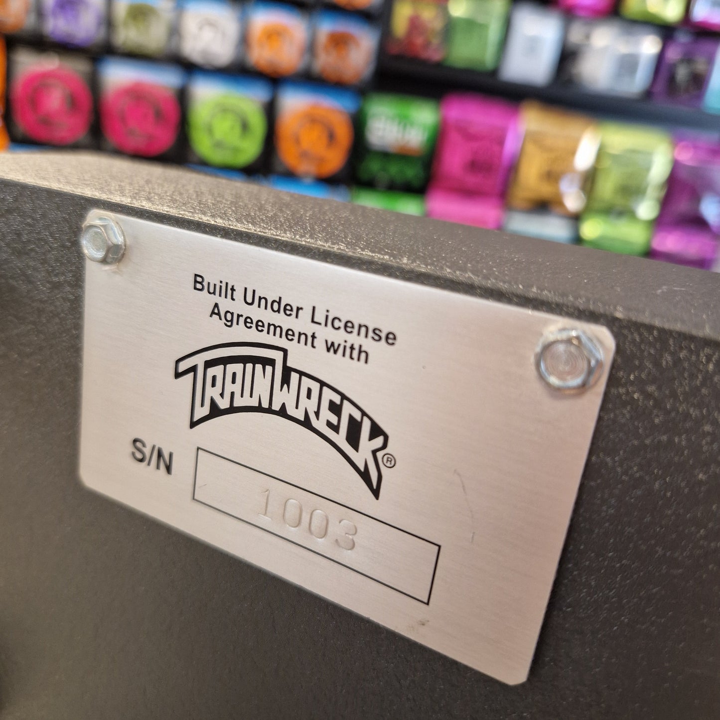 Pre-Owned Dr. Z Trainwreck Metallic label with 'TrailRack' branding on a product with colorful components in the background.