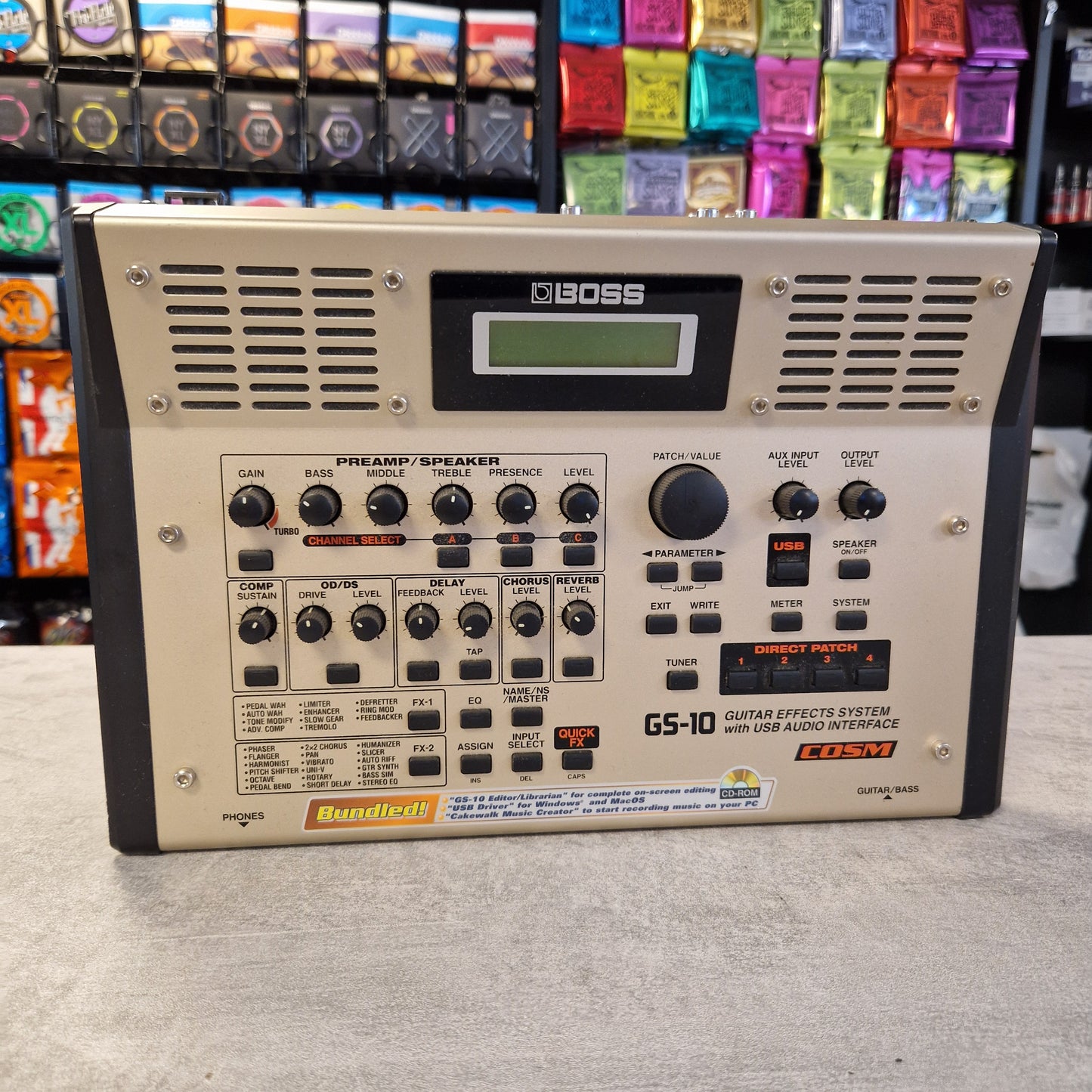 Pre-Owned Boss GS-10 Guitar effects pedal with multiple controls and display on a gray surface