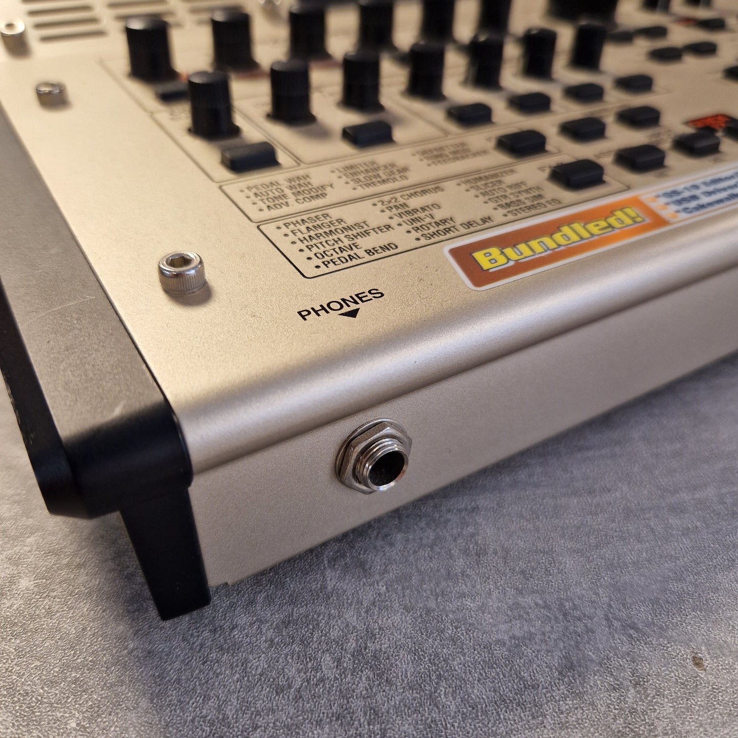Pre-Owned Boss GS-10 Close-up of a control panel with knobs and labels on a gray surface