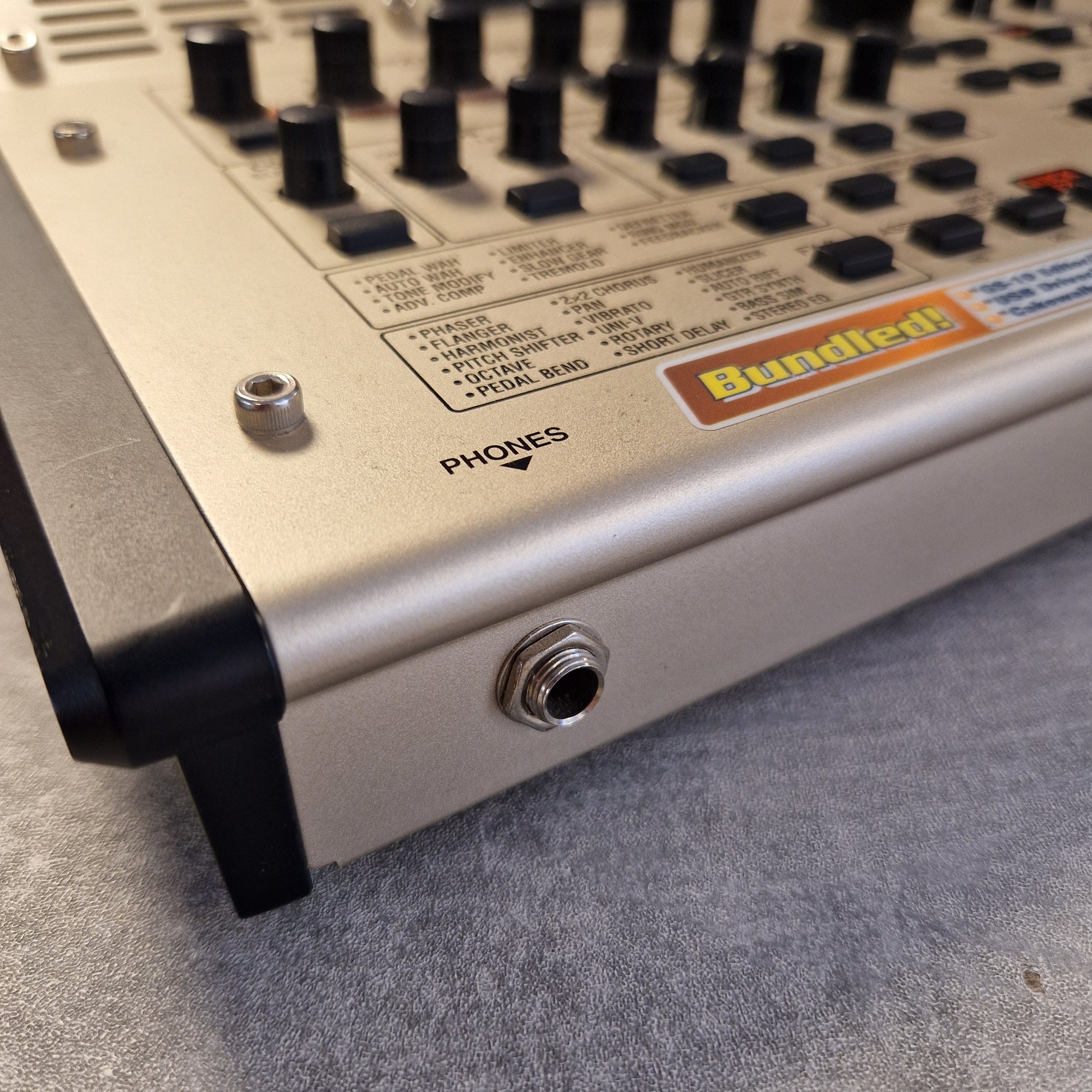Pre-Owned Boss GS-10 Close-up of a control panel with knobs and labels on a gray surface