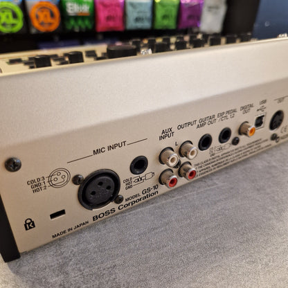 Pre-Owned Boss GS-10 Close-up of an electronic device with various connectors and labels on a gray background.