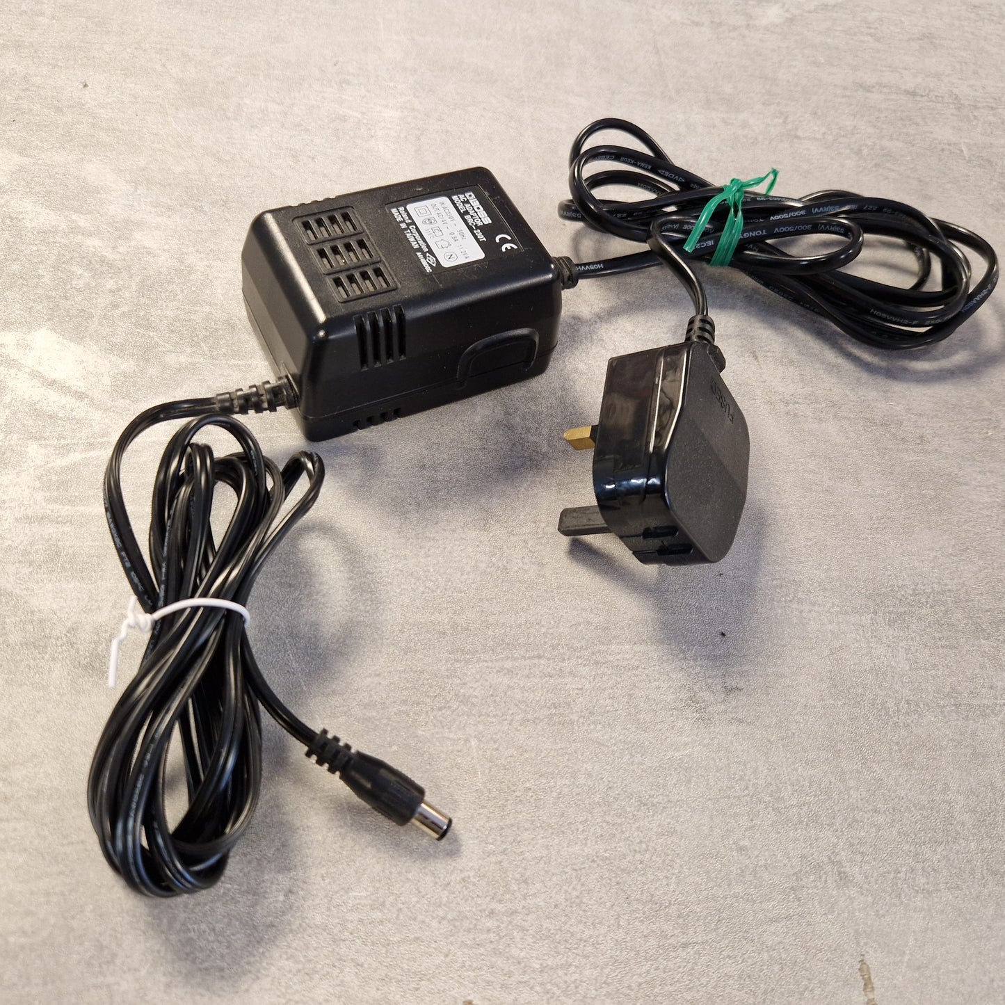 Pre-Owned Boss GS-10 Power adapter with UK plug on a gray background