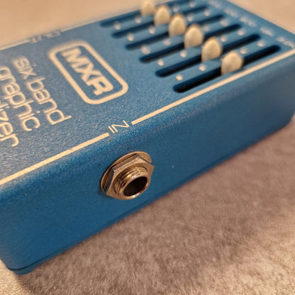 Pre-Owned MXR MX-109 Blue MXR guitar effects pedal with six band graphic equalizer on a textured surface