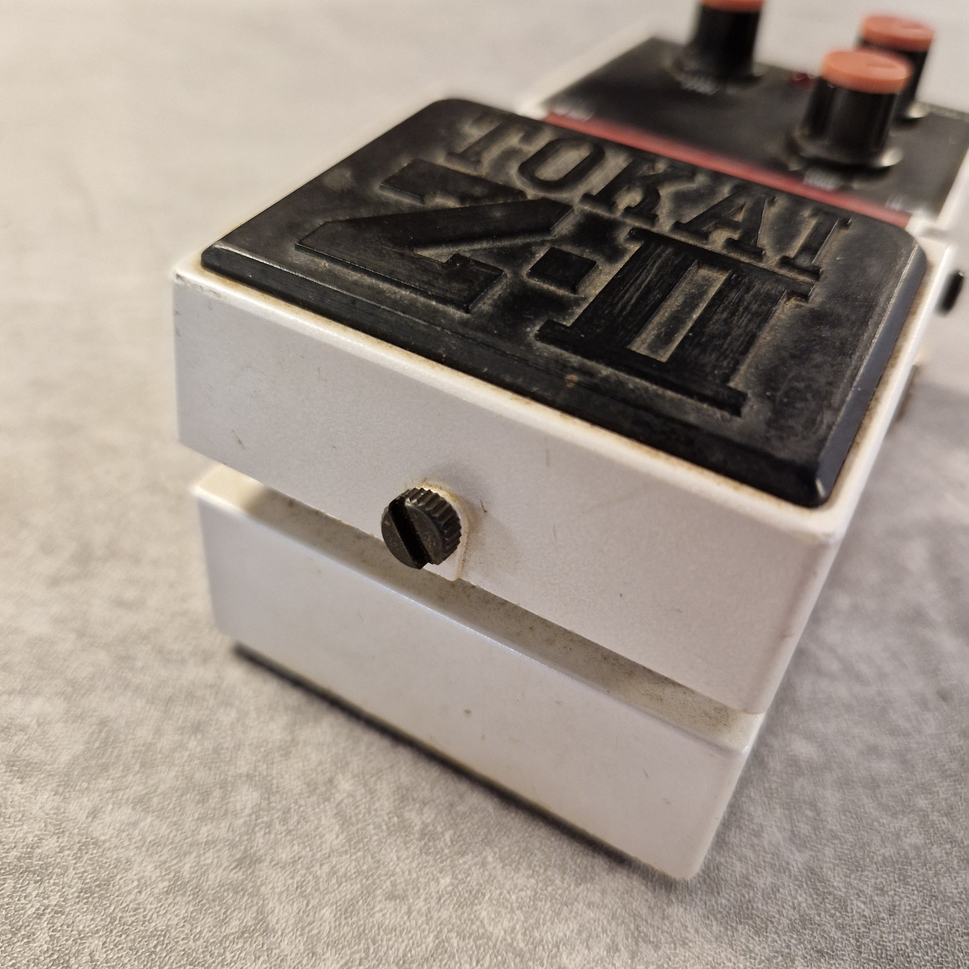 Pre-Owned Tokai Z-II TOD-2 Close-up of a metal component with branding on a gray background