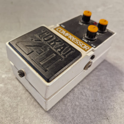 Pre-Owned Tokai Z-II TCO-2 Compressor pedal with 'Tokai' branding on a gray surface