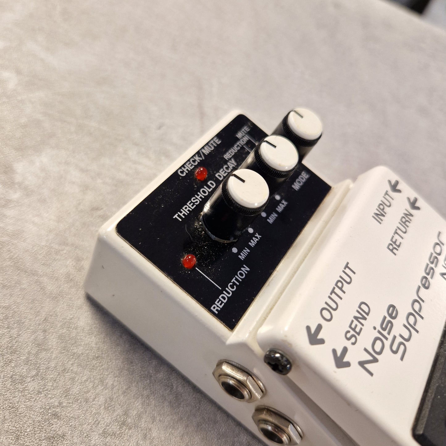 Pre-Owned Boss NS-2 Guitar effects pedal with labeled ports on a gray surface