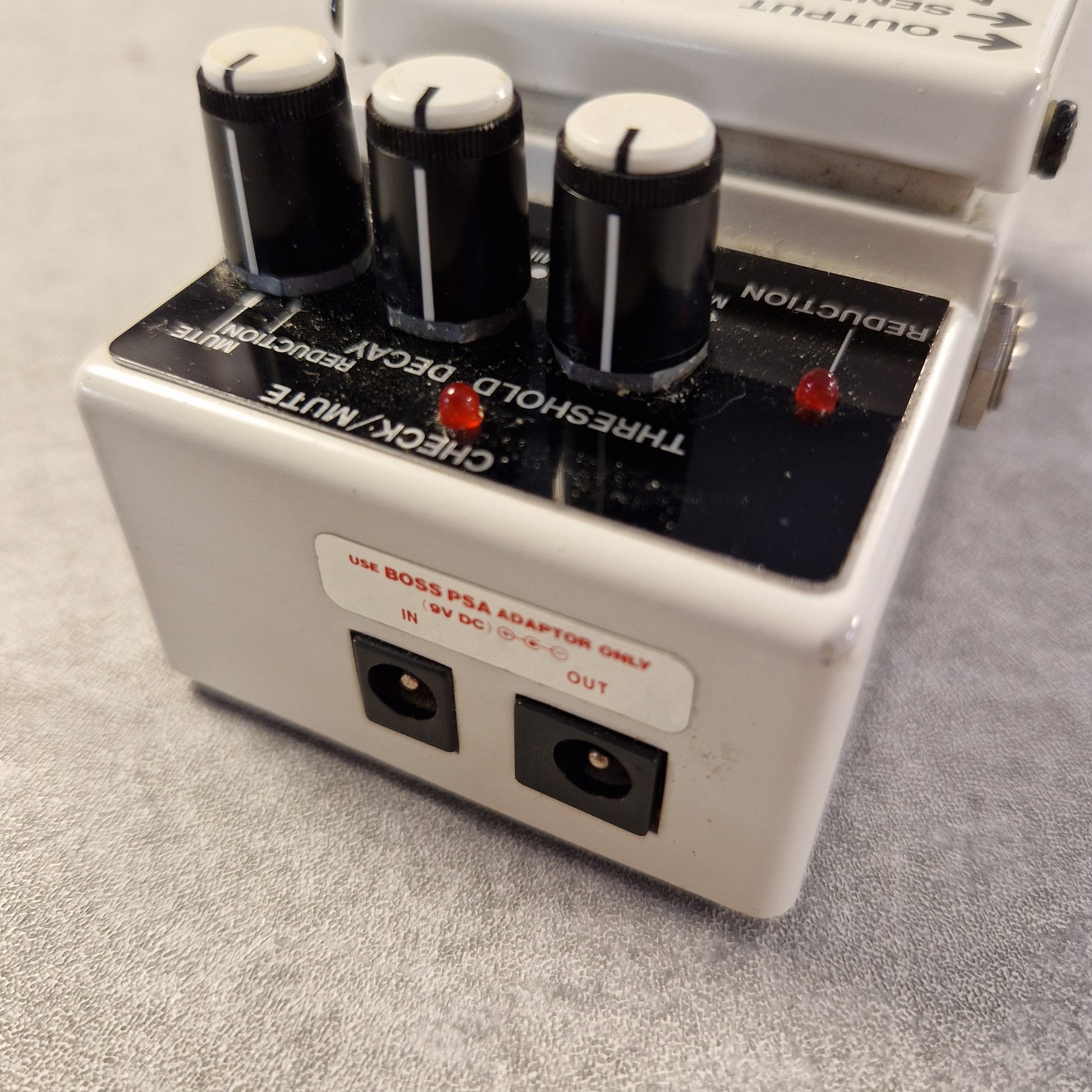 Pre-Owned Boss NS-2 Vintage audio effects pedal with control knobs on a gray surface