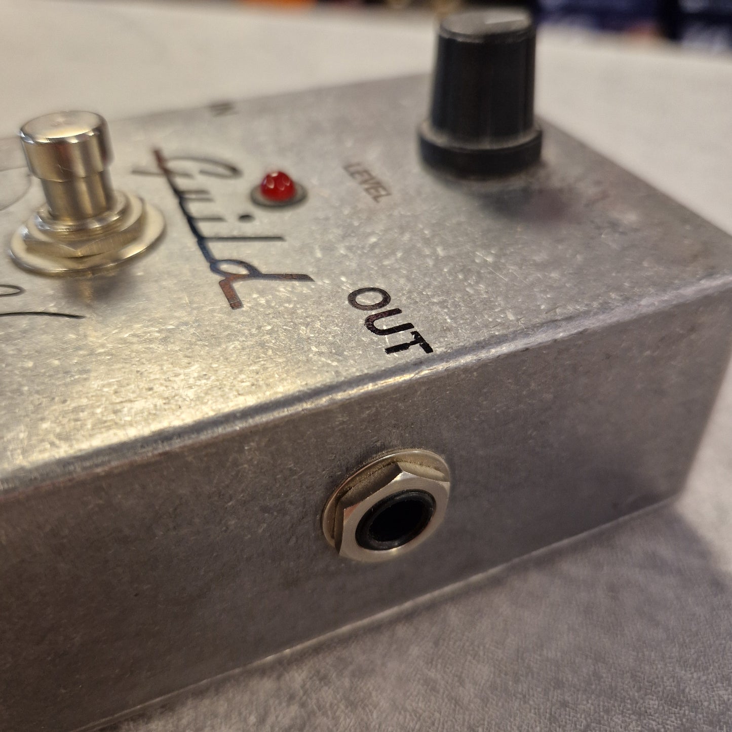 Pre-Owned Guild Brian May Close-up of a guitar effects pedal with 'Guild' branding.