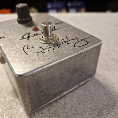 Pre-Owned Guild Brian May Metal footswitch with branding on a blurred background