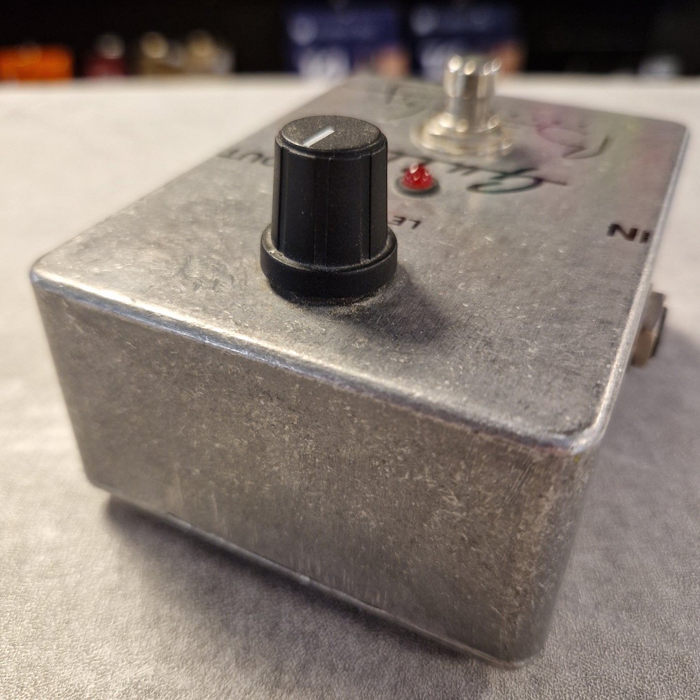 Pre-Owned Guild Brian May Metal toggle switch with a red indicator light on a gray surface