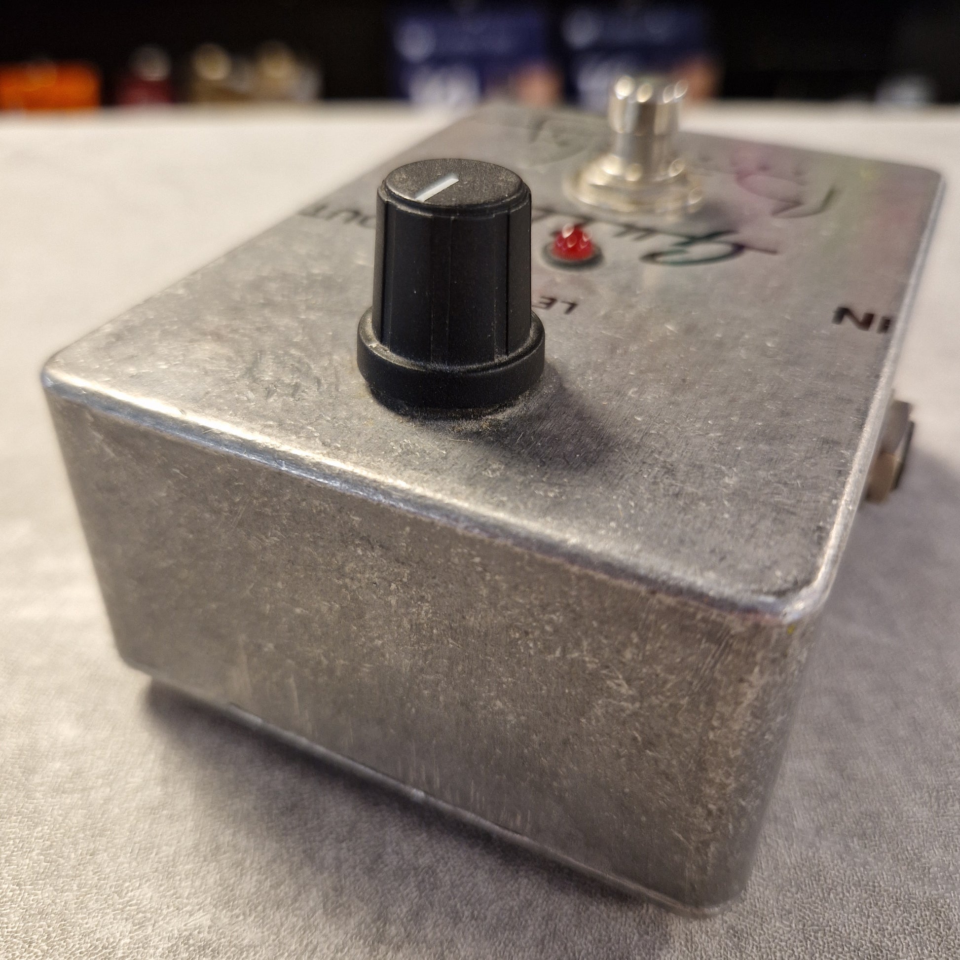 Pre-Owned Guild Brian May Metal toggle switch with a red indicator light on a gray surface